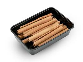 cinnamon sticks in plastic box isolated on white background ,include clipping path photo