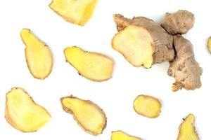 sliced fresh ginger root isolated on white background photo