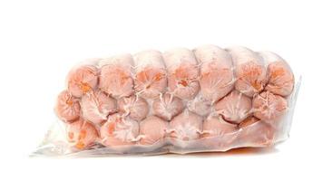 closeup frozen sausage in plastic bag with ice crystals isolated on white background photo