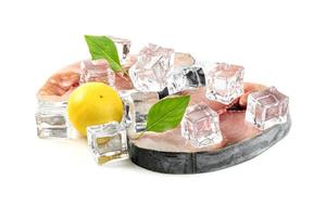 Spanish mackerel slice or spotted mackerels with lemon and leaf basil and ice cube isolated on white background ,Scomberomorus photo