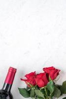 Top view of Valentine day gift with rose and wine, festive meal design concept photo