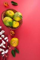 Top view of fresh tangerine mandarin orange on red background for Chinese lunar new year. photo