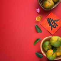 Top view of fresh tangerine mandarin orange on red background for Chinese lunar new year. photo