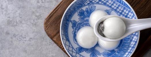 Top view of big tangyuan yuanxiao in a bowl on gray background for lunar new year food. photo