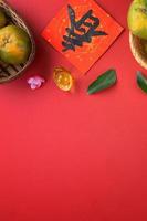 Top view of fresh tangerine mandarin orange on red background for Chinese lunar new year. photo