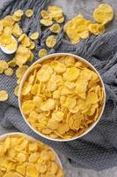Corn flakes bowl sweets on gray cement background, top view flat lay layout design, fresh and healthy breakbast concept. photo