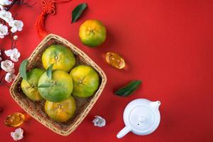 Top view of fresh tangerine mandarin orange on red background for Chinese lunar new year. photo