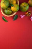 Top view of fresh tangerine mandarin orange on red background for Chinese lunar new year. photo