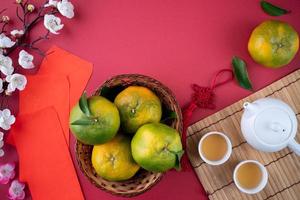 Top view of fresh tangerine mandarin orange on red background for Chinese lunar new year. photo