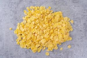 Corn flakes bowl sweets on gray cement background, top view flat lay layout design, fresh and healthy breakbast concept. photo