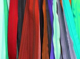 Detailed close up view on samples of cloth and fabrics in different colors found at a fabrics market photo