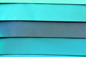 Detailed close up view on samples of cloth and fabrics in different colors found at a fabrics market photo