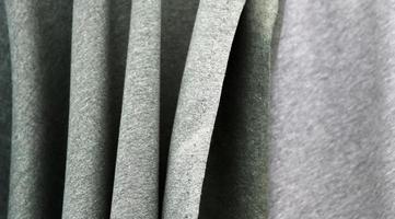 Detailed close up view on samples of cloth and fabrics in different colors found at a fabrics market photo
