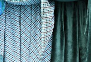 Detailed close up view on samples of cloth and fabrics in different colors found at a fabrics market photo