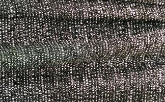 Detailed close up view on samples of cloth and fabrics in different colors found at a fabrics market photo