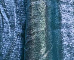 Detailed close up view on samples of cloth and fabrics in different colors found at a fabrics market photo