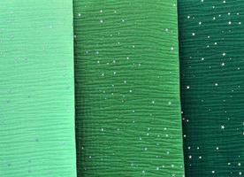 Detailed close up view on samples of cloth and fabrics in different colors found at a fabrics market photo
