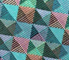 Detailed close up view on samples of cloth and fabrics in different colors found at a fabrics market photo