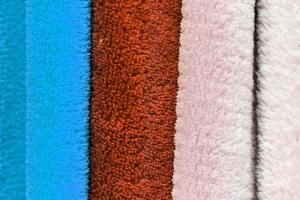 Detailed close up view on samples of cloth and fabrics in different colors found at a fabrics market photo