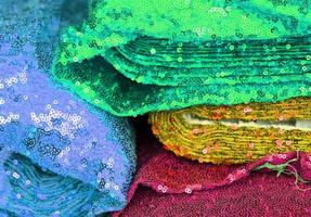 Detailed close up view on samples of cloth and fabrics in different colors found at a fabrics market photo