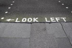 Different signs and marking painted on the ashpalt of streets and roads. photo