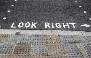 Different signs and marking painted on the ashpalt of streets and roads. photo