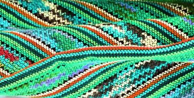 Detailed close up view on samples of cloth and fabrics in different colors found at a fabrics market photo