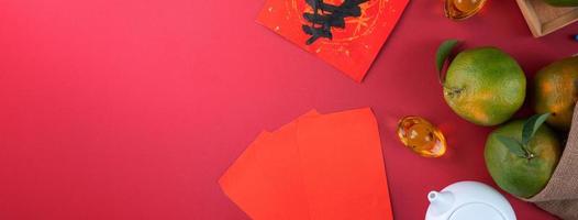 Top view of fresh tangerine mandarin orange on red background for Chinese lunar new year. photo