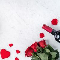 Top view of Valentine day gift with rose and wine, festive meal design concept photo