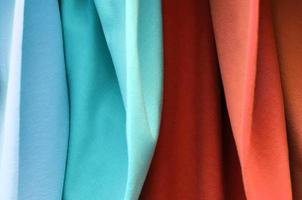 Detailed close up view on samples of cloth and fabrics in different colors found at a fabrics market photo