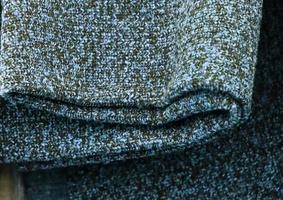 Detailed close up view on samples of cloth and fabrics in different colors found at a fabrics market photo