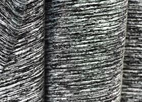 Detailed close up view on samples of cloth and fabrics in different colors found at a fabrics market photo