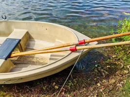 Rowboat lying at the coast of a lake on a sunny day photo