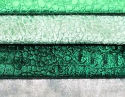 Detailed close up view on samples of cloth and fabrics in different colors found at a fabrics market photo
