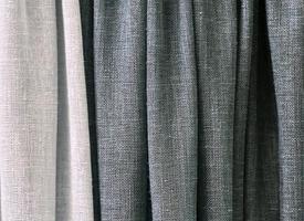 Detailed close up view on samples of cloth and fabrics in different colors found at a fabrics market photo