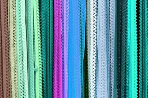 Detailed close up view on samples of cloth and fabrics in different colors found at a fabrics market photo