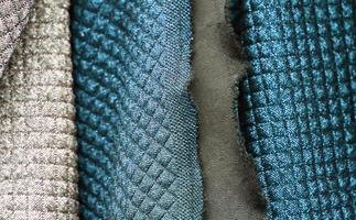 Detailed close up view on samples of cloth and fabrics in different colors found at a fabrics market photo