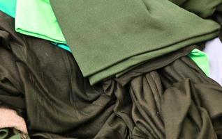 Detailed close up view on samples of cloth and fabrics in different colors found at a fabrics market photo