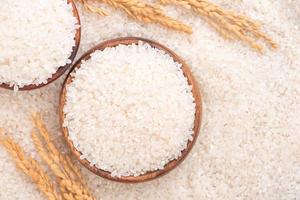 Raw rice in a bowl and full frame in the white background table, top view overhead shot, close up photo