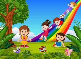 Cartoon kids sliding down the rainbow vector