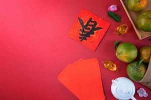 Top view of fresh tangerine mandarin orange on red background for Chinese lunar new year. photo