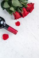 Top view of Valentine day gift with rose and wine, festive meal design concept photo