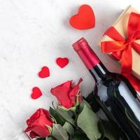 Top view of Valentine day gift with rose and wine, festive meal design concept photo