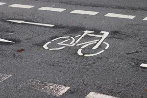 Different signs and marking painted on the ashpalt of streets and roads. photo