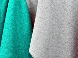 Detailed close up view on samples of cloth and fabrics in different colors found at a fabrics market photo