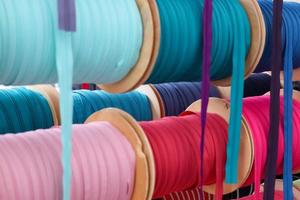 Detailed close up view on samples of cloth and fabrics in different colors found at a fabrics market photo