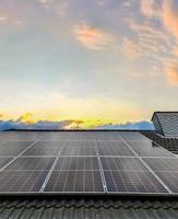 Solar panels producing clean energy on a roof of a residential house photo