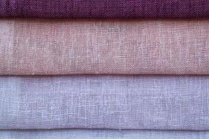 Detailed close up view on samples of cloth and fabrics in different colors found at a fabrics market photo