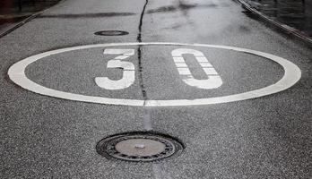 Different signs and marking painted on the ashpalt of streets and roads. photo