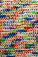 Detailed close up view on samples of cloth and fabrics in different colors found at a fabrics market photo